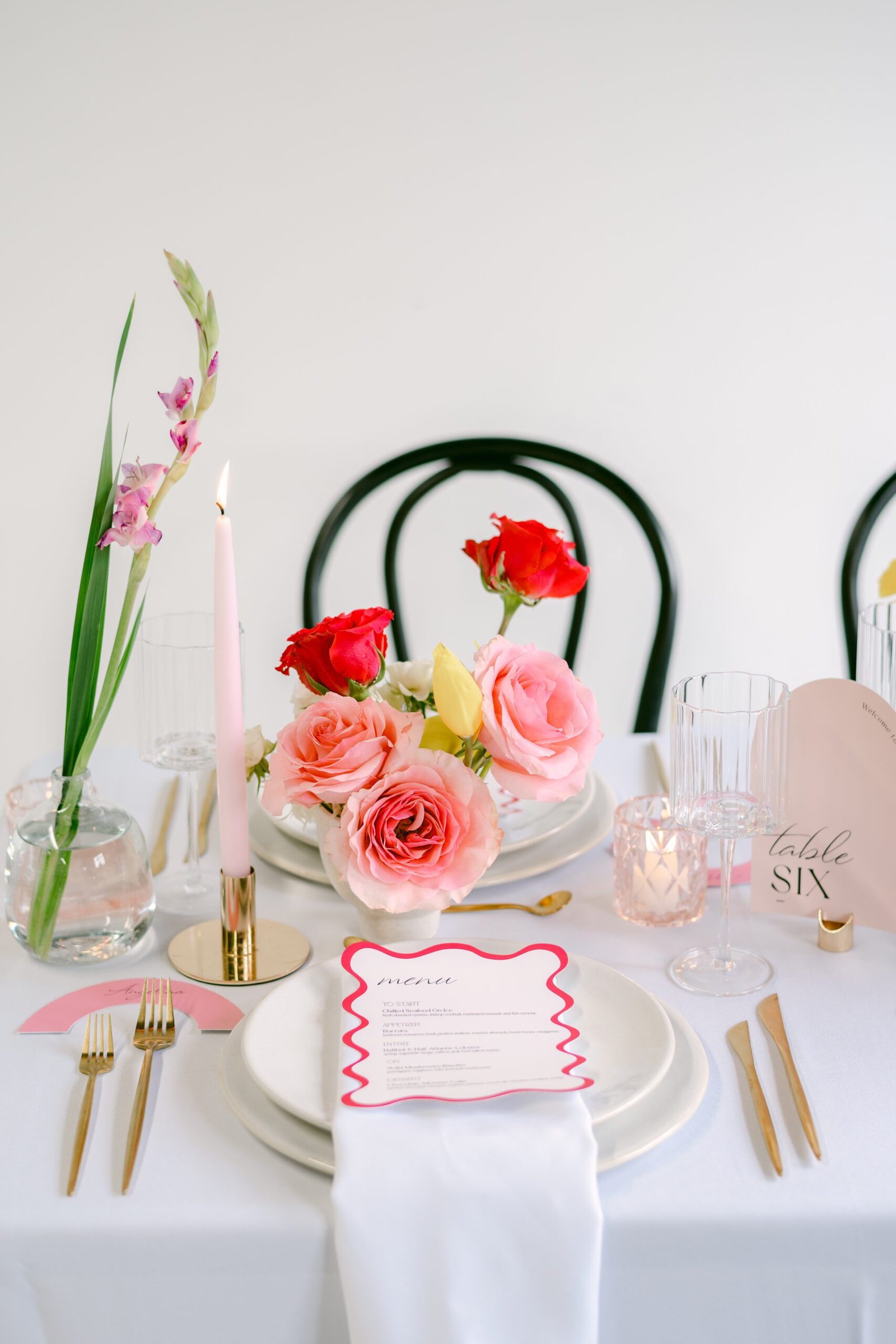 Event florist Surrey creating elegant table arrangements with seasonal flowers for a celebration.