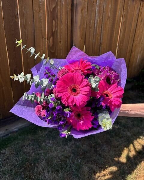 Pink and purple flower bouquet with gerberas, statice , alstroemeria and eucalyptus greenery