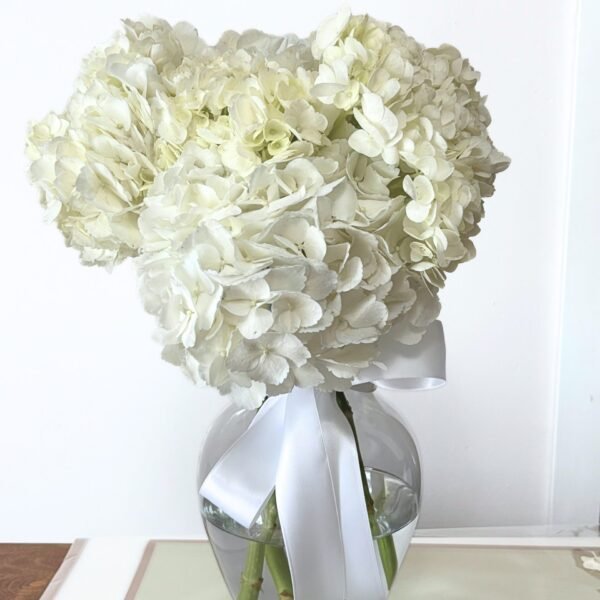 white hydrangea bouquet in a glass vase