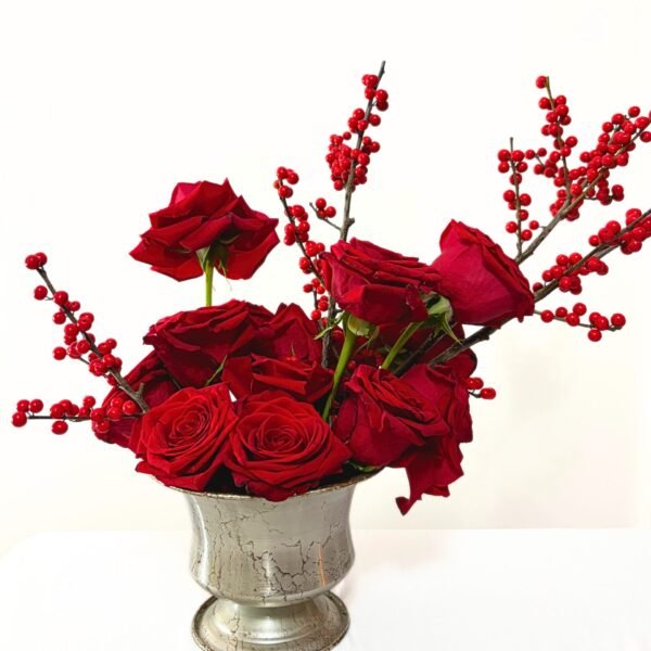 Modern red floral arrangement with roses and ilex berries for Christmas décor
