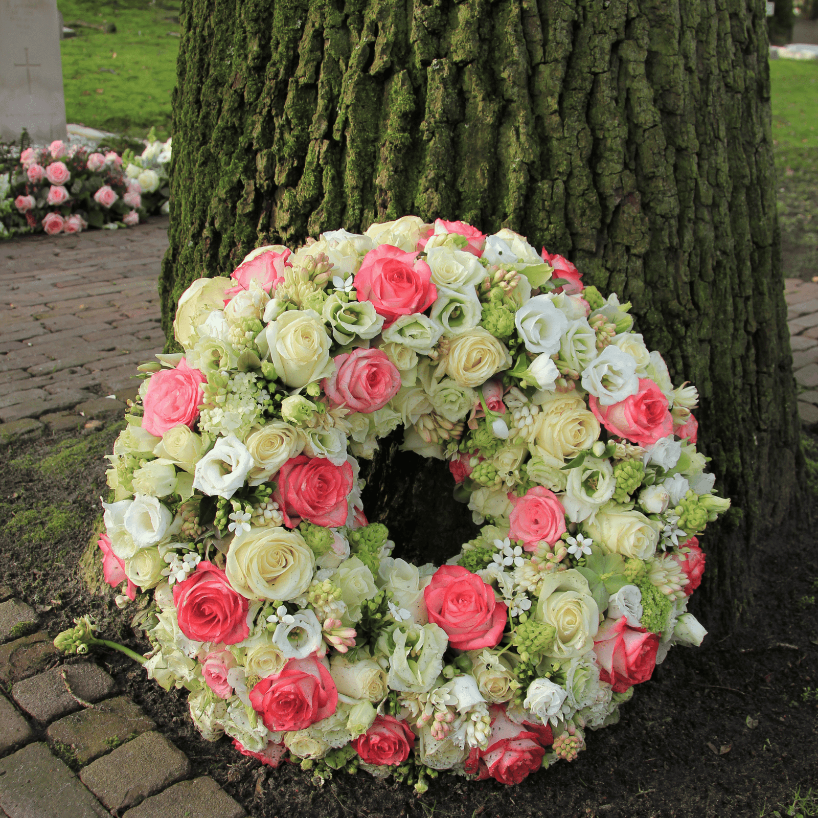 Elegant circular funeral wreath created by Petal & Bulb, offering funeral flowers Surrey.