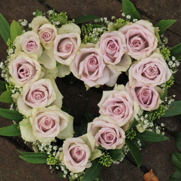 Funeral wreath with delicate roses created by a Surrey florist providing funeral flowers Surrey.