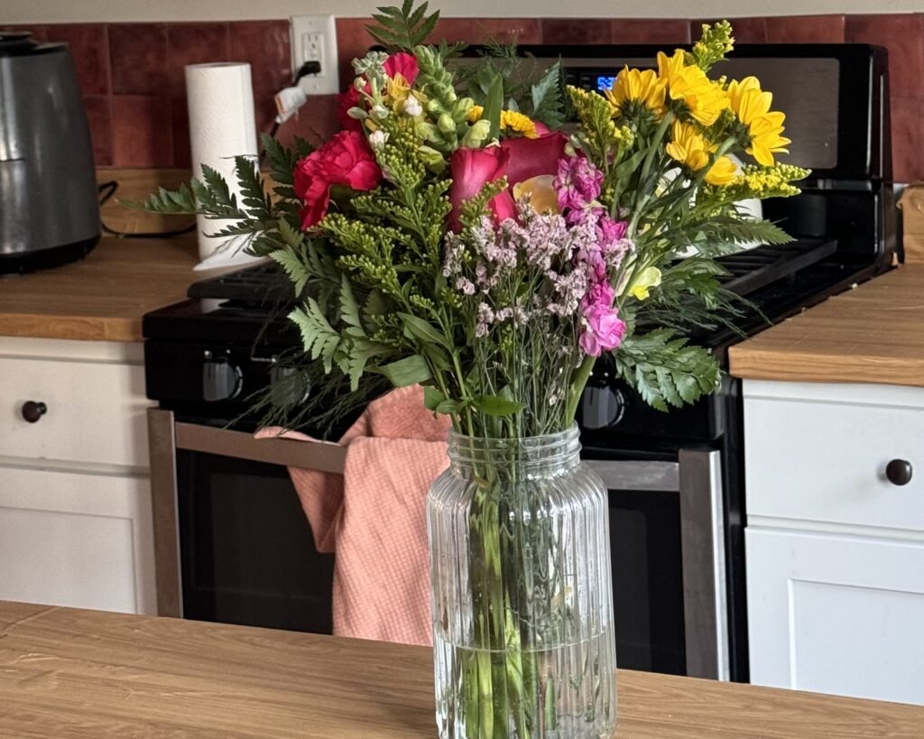flower arrangement in a glass vase designed by a florist in surrey