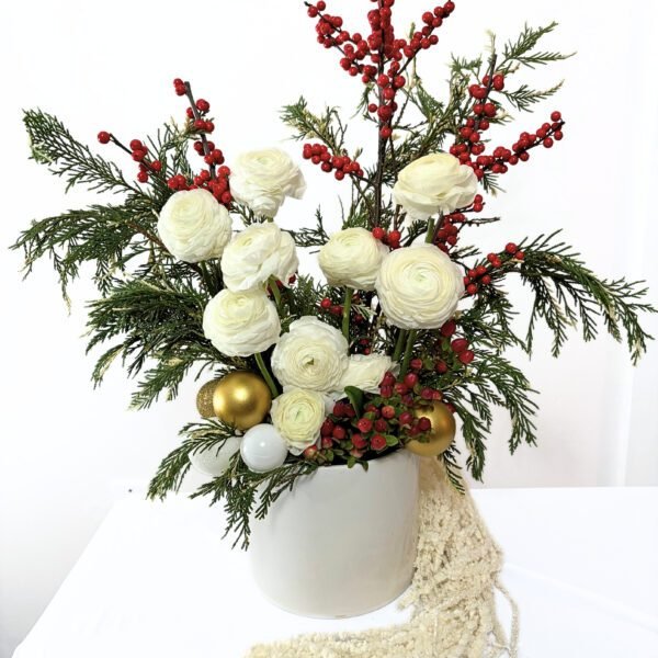 Statement Christmas floral arrangement with white ranunculus, holiday berries and winter greenery